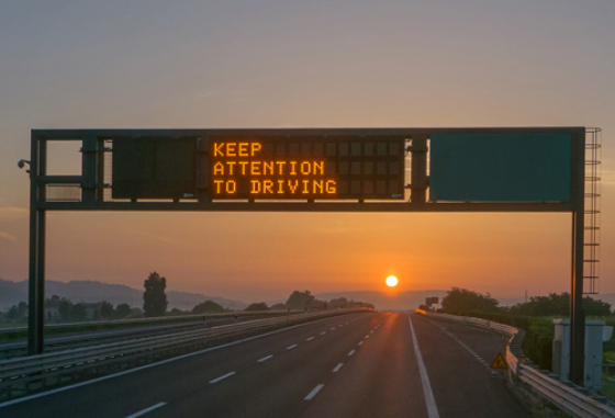 Road sign saying Keep Attention To Driving